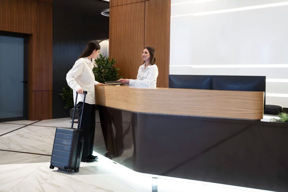 woman talking with hotel receptionist lobby