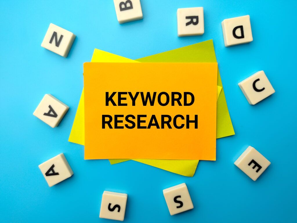 colored paper toys word with text keyword research blue background