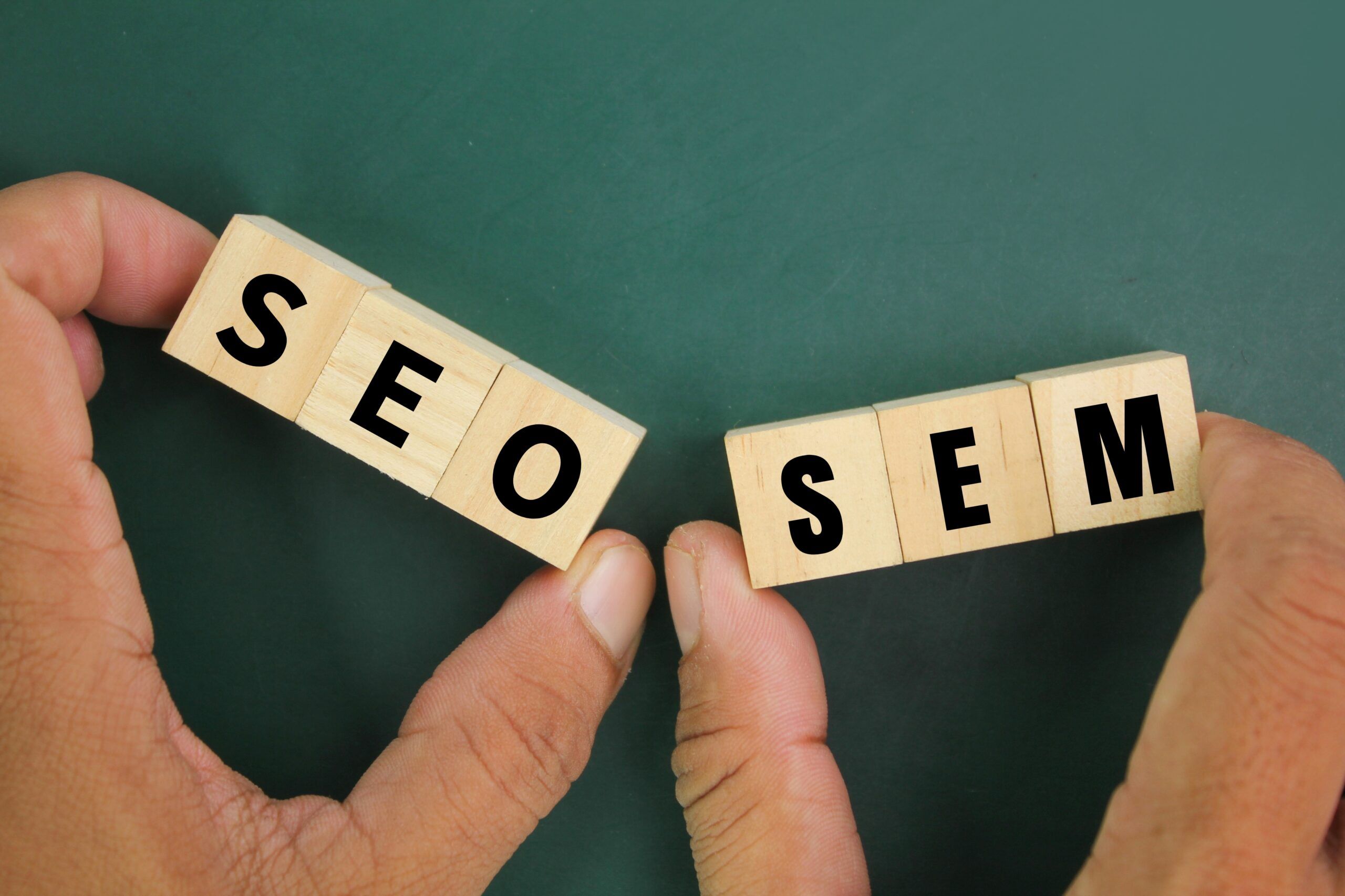 hand holding wooden cube with letters sem seo concept search engine optimization scaled